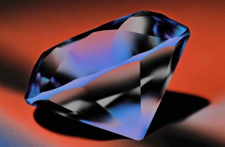 Ein blauer und schwarzer, facettierter Edelstein auf orange-rotem Hintergrund.